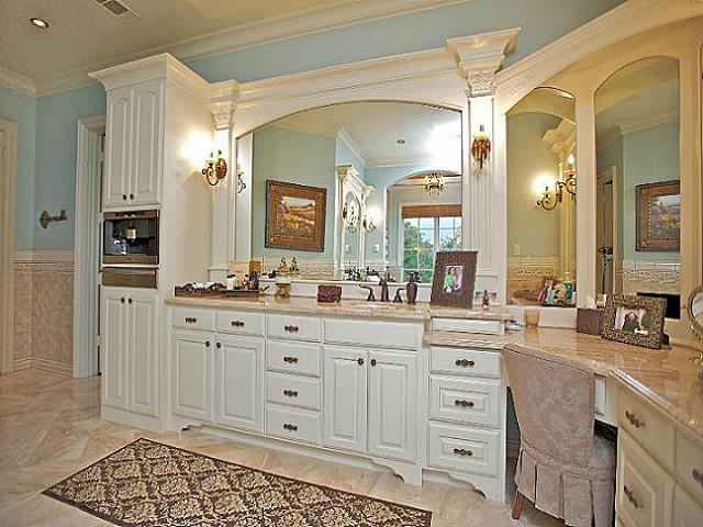 spacious master bathroom with alcove tub and corner double sink vanity